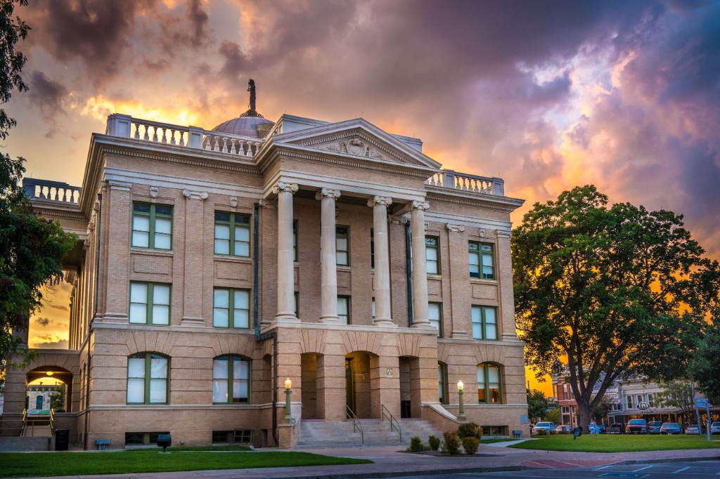 Courthouse exterior with columns, representing jury trials and litigation